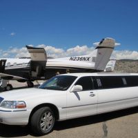 Limo parked next to private plane loading luggage