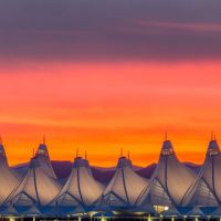 Denver International Airport with orange and purple sunset